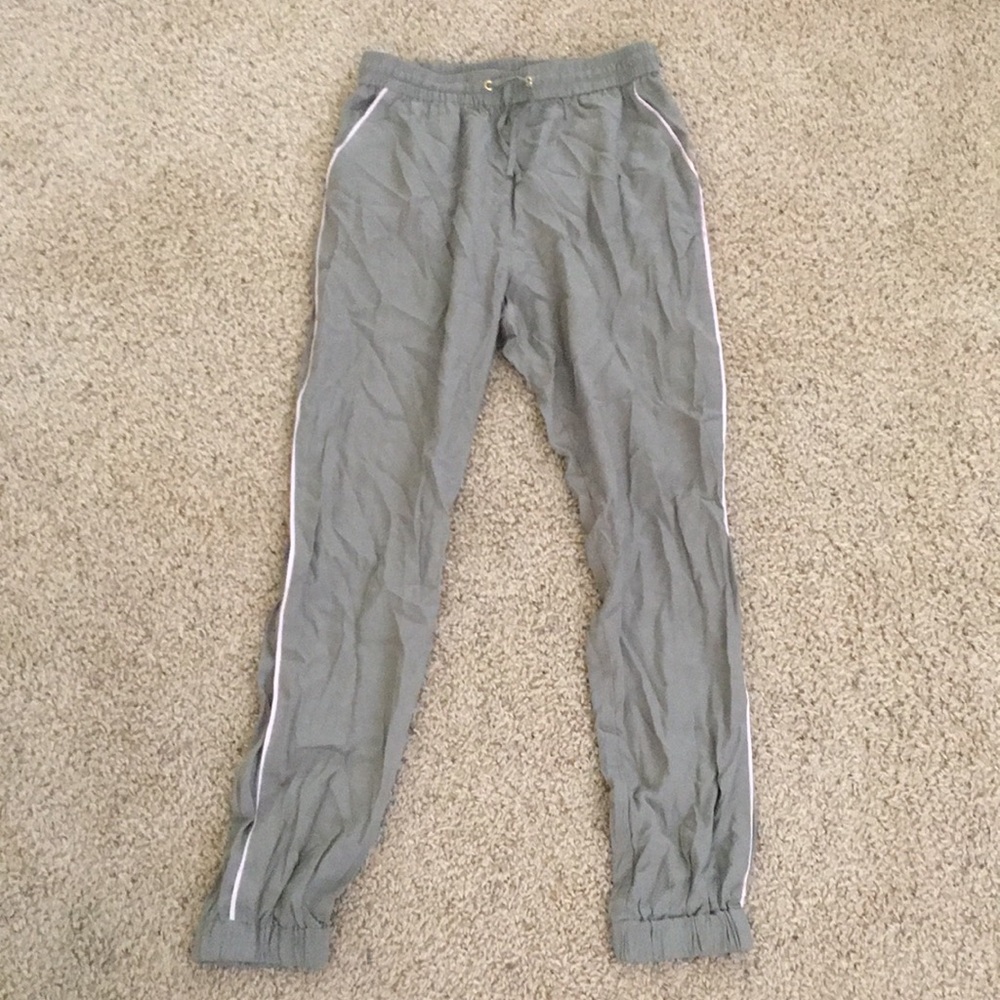 Green joggers with pink stripes on the sides.